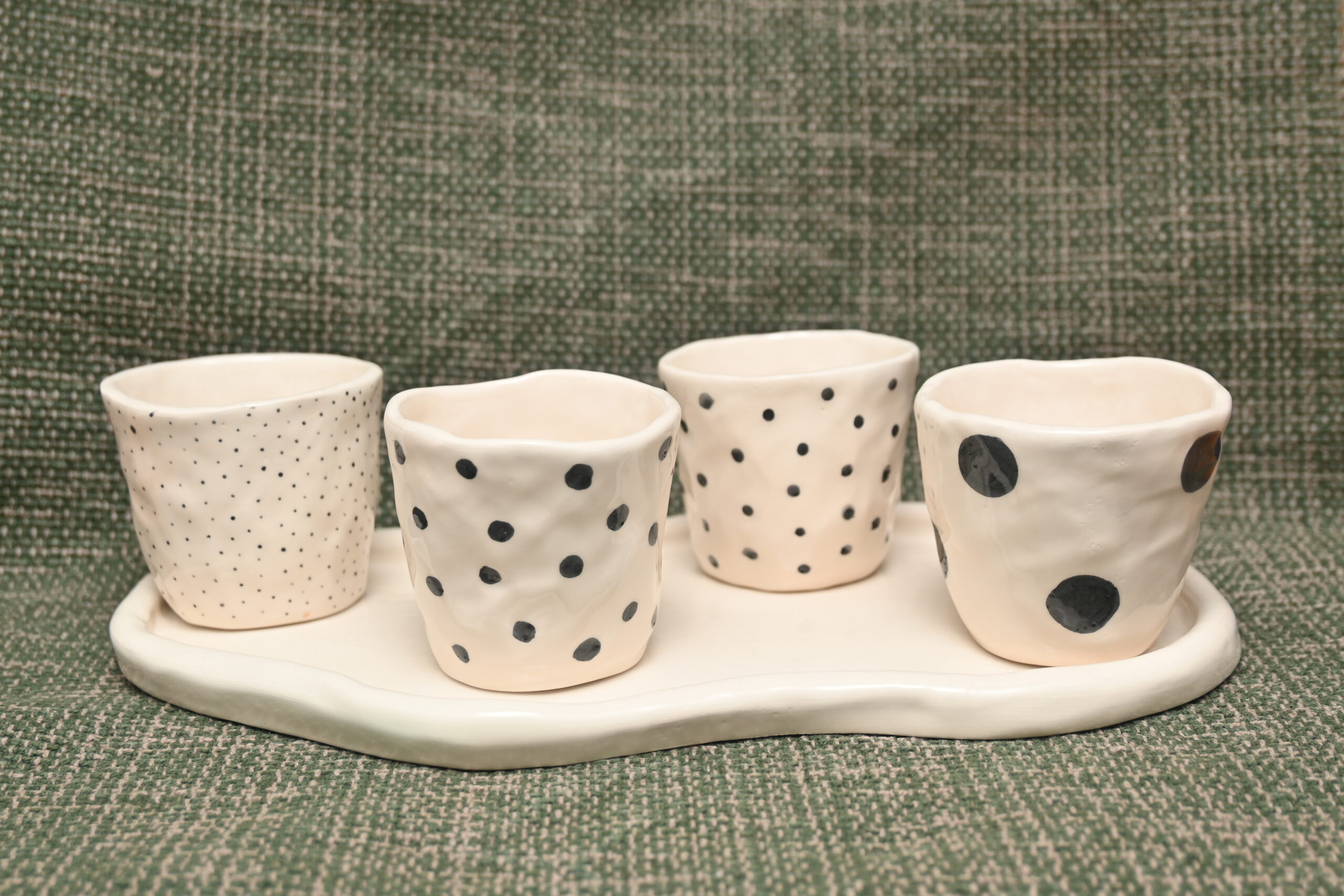 Fyra muggar av keramik med bricka